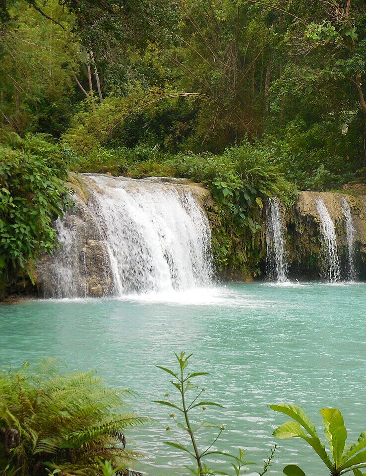 Cambugahay Falls in Lazi, Siquijor, with turquoise pools below the cascading tiers